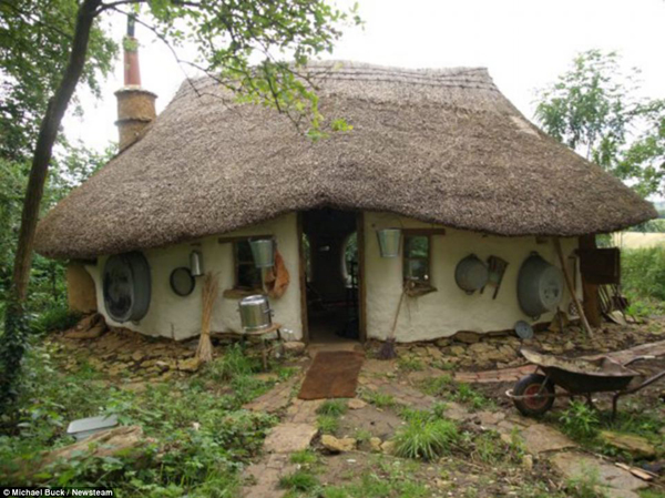 Michael Buck built this house at the bottom of his garden for just £150 using natural or unwanted materials he found in skips (dumpsters)